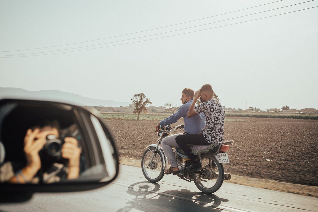 Two motorcyclists riding along a rural highway Isfahan, iran, representing resilience and shared journey